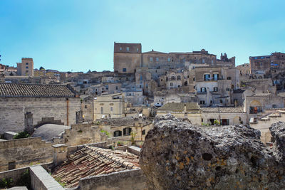 Buildings in city against clear sky