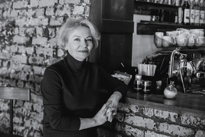 Portrait of woman standing at market stall