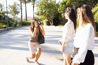 Rear view of women walking in park