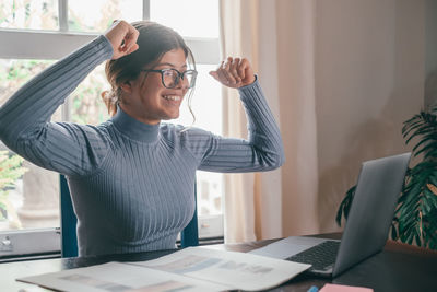 Side view of businesswoman working at office