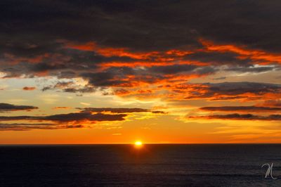 Scenic view of sea against orange sky