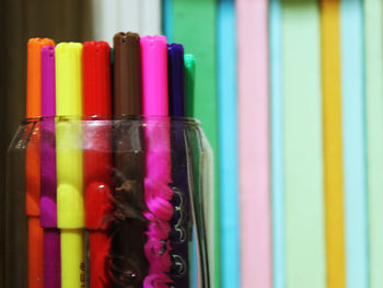 Close-up of colorful felt tip pens in desk organizer on table