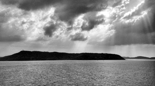 Scenic view of sea against cloudy sky