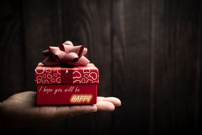 Close-up of hand holding red box