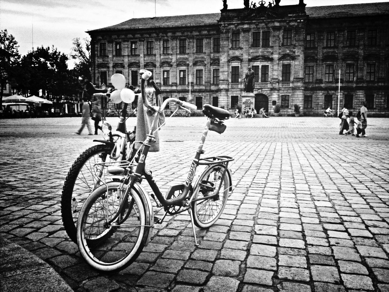 bicycle, building exterior, architecture, transportation, built structure, mode of transport, cobblestone, land vehicle, street, city, men, lifestyles, city life, person, incidental people, travel, sidewalk, leisure activity, outdoors