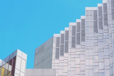 Low angle view of modern building against clear blue sky