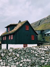 View of red and house against sky