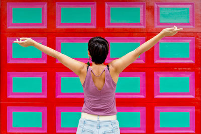 Rear view of woman standing against blue sky