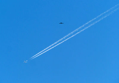 Low angle view of vapor trail in blue sky