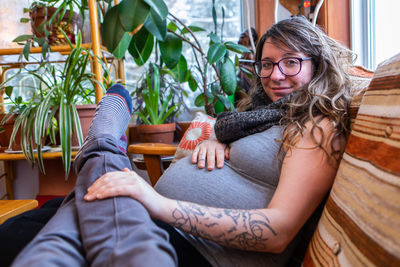 Portrait of woman sitting at home