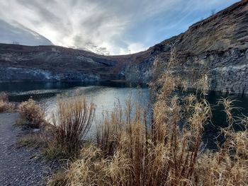 Scenic view of lake and mountains against sky