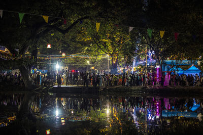 Group of people on lake at night