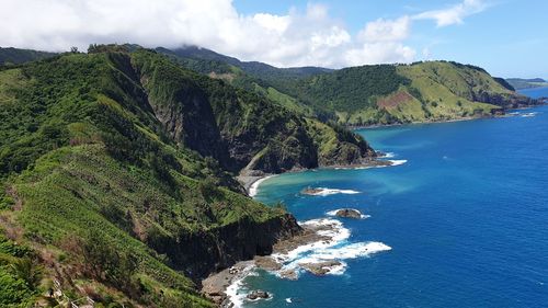 High angle view of sea and mountains against sky