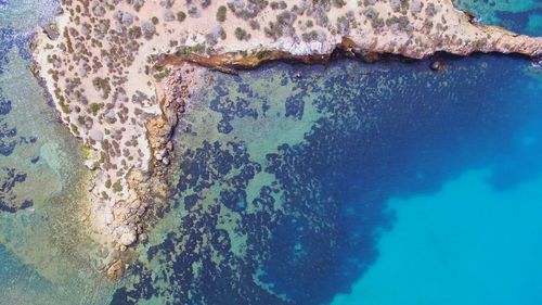 High angle view of rock formation in sea