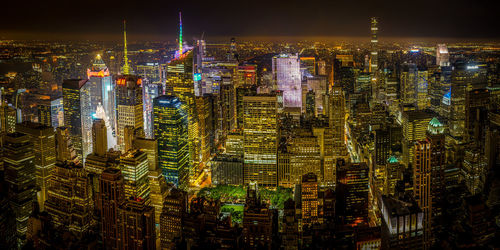 High angle view of illuminated buildings in city at night