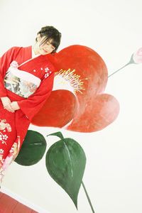 High angle view of woman standing against red background