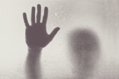 Shadow of person seen from frosted glass