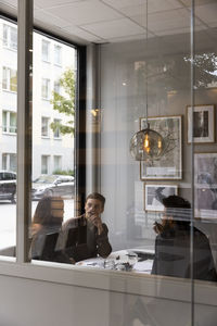 Couple discussing with real estate agent in modern office