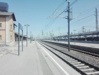 Railroad station platform against clear sky