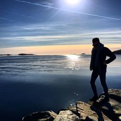 Man standing by sea against sky