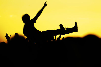 Silhouette people against clear sky during sunset