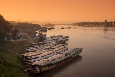 High angle view of boats on shore against sky during sunset