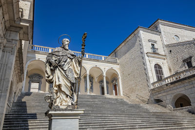 Low angle view of statue against blue sky