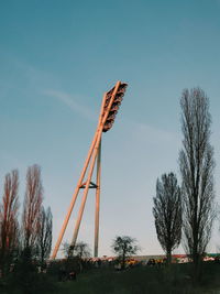 Low angle view of traditional windmill on field against sky