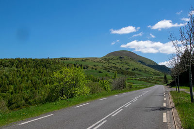 Empty road along countryside landscape