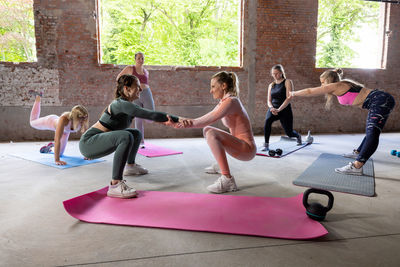 Side view of woman exercising in gym