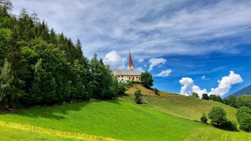 Scenic view of trees and buildings against sky