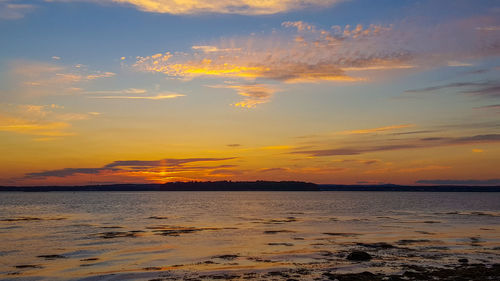 Scenic view of sea against orange sky