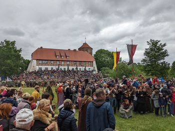 Group of people on field against sky