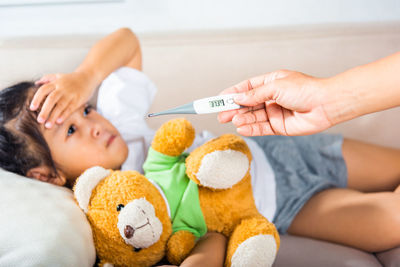 High angle view of doctor examining patient at home