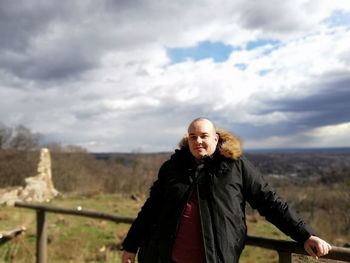 Portrait of woman standing in winter against sky