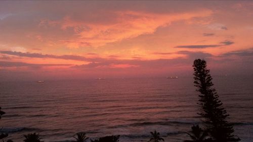 Scenic view of sea against orange sky