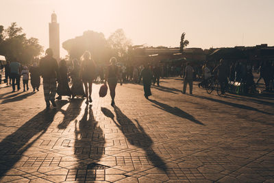 People on street in city against sky