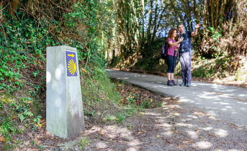 Rear view of woman walking on road