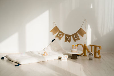 Photo zone for shooting a one-year-old baby's birthday in pastel colors. mattress, wooden toys 