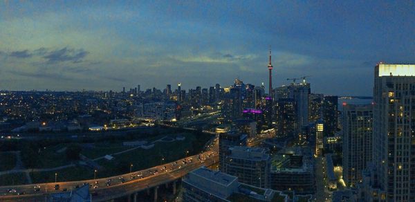 High angle view of city lit up at dusk