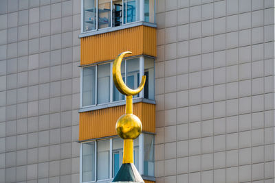 Low angle view of yellow window on building