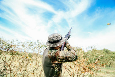 Low angle view of hunter hunting against sky