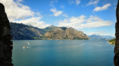Scenic view of sea and mountains against sky