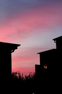 Silhouette of built structure at sunset