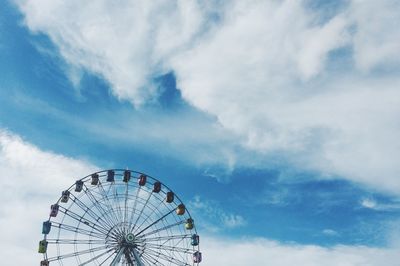 Low angle view of ferris wheel against sky