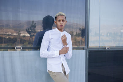 Portrait of young man standing in office