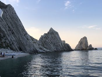 Scenic view of rocks in sea against sky
