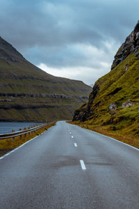 Road amidst mountains against sky