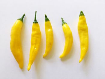 Close-up of yellow bell peppers on white background