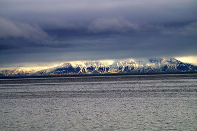 Scenic view of mountains against cloudy sky